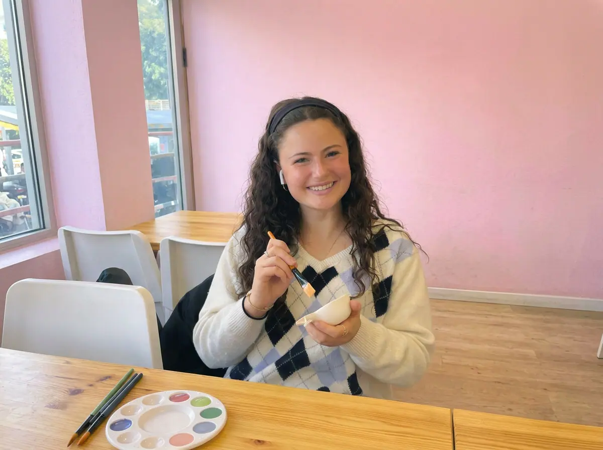 Smiling painter holding a brush and bowl